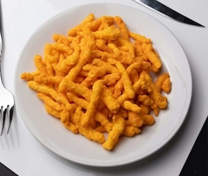 overhead picture of a plate filled with rap snacks' snoop dogg o.g. bar-b-que cheddar puffs