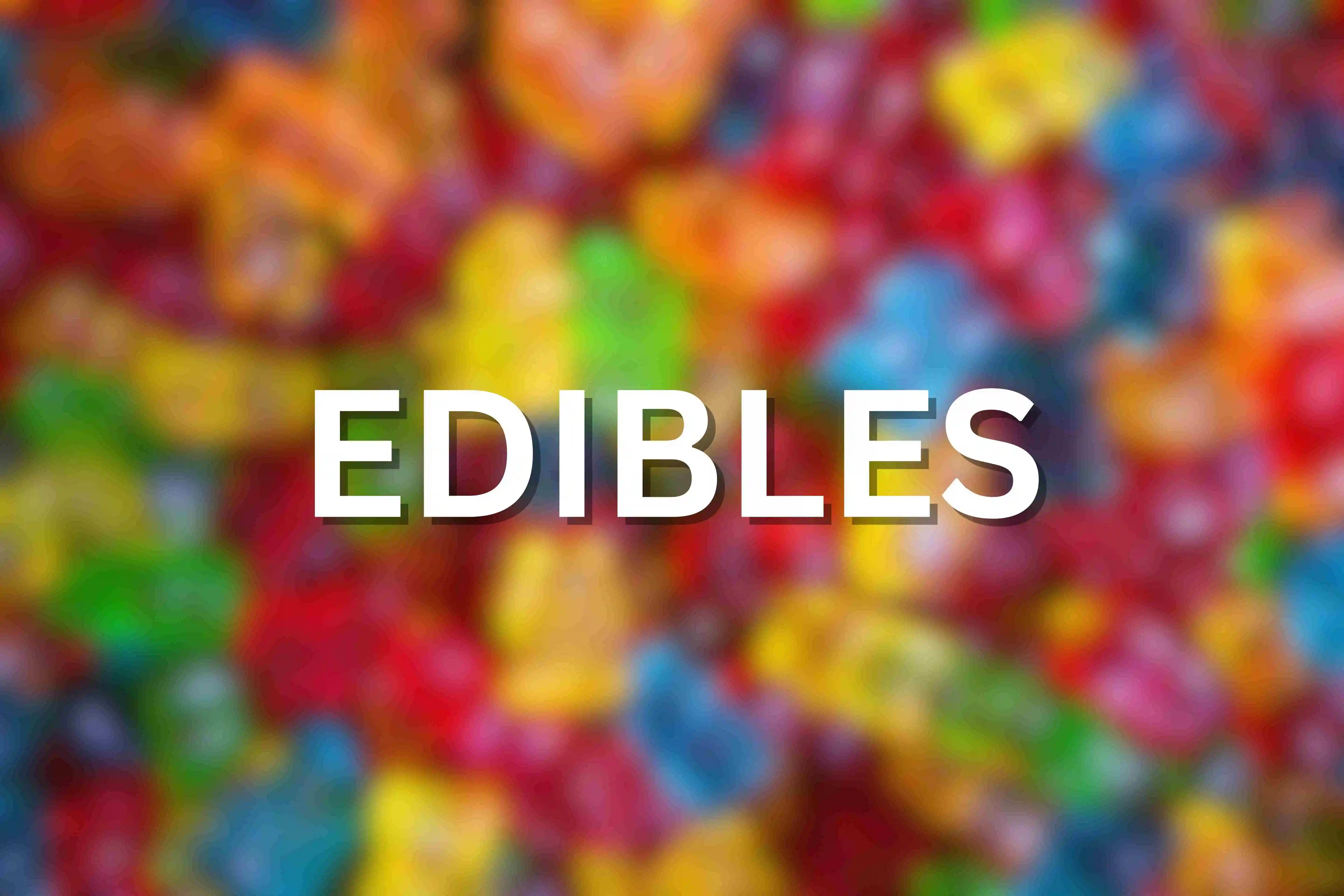 blurred image of gummy bear THC edibles with the text EDIBLES as an overlay