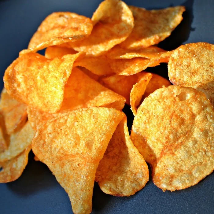close image of snoop dogg O.G. bar-b-que potato chips on a purple background