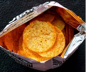 overhead picture of an open bag of rap snacks' snoop dogg o.g. bar-b-que potato chips